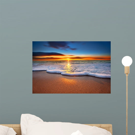 Sunrise light shining on ocean waves. Wall Mural