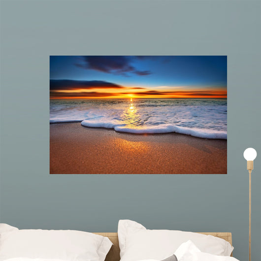 Sunrise light shining on ocean waves. Wall Mural