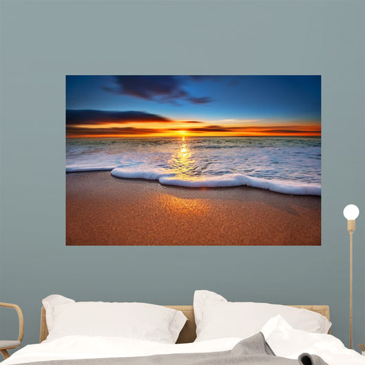 Sunrise light shining on ocean waves. Wall Mural