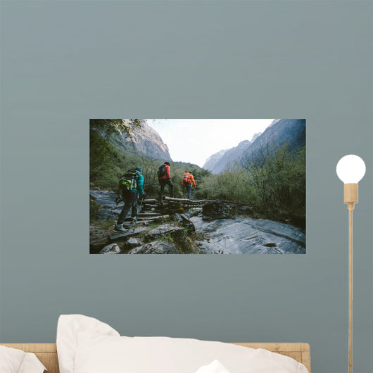 Group of trekkers cross the bridge Wall Mural