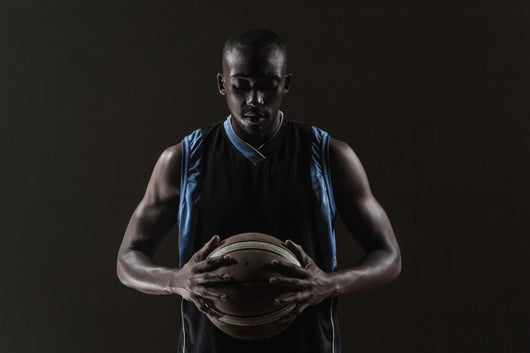Portrait of basketball player holding a ball Wall Mural