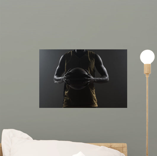 Close up on basketball player holding a ball Wall Mural