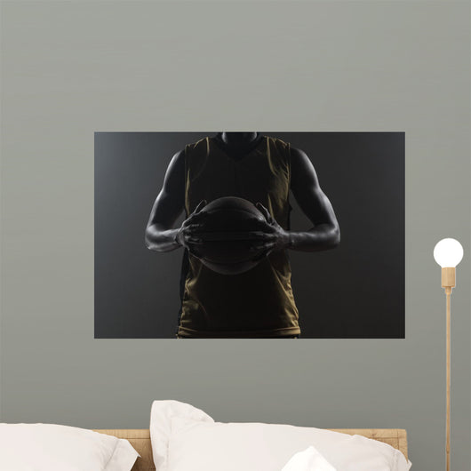 Close up on basketball player holding a ball Wall Mural