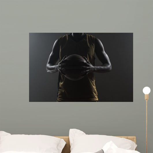 Close up on basketball player holding a ball Wall Mural