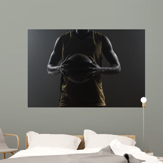 Close up on basketball player holding a ball Wall Mural