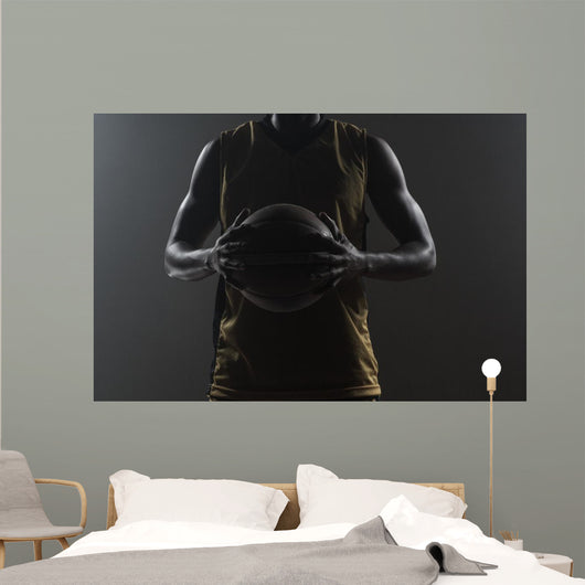 Close up on basketball player holding a ball Wall Mural