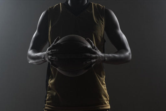 Close up on basketball player holding a ball Wall Mural