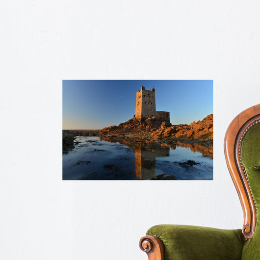 Seymour Tower, Jersey, U.K. Wide angle image of a military 19th century Napoleonic Wars tower shot on a Spring low tide one mile from shore at sunset. Wall Mural
