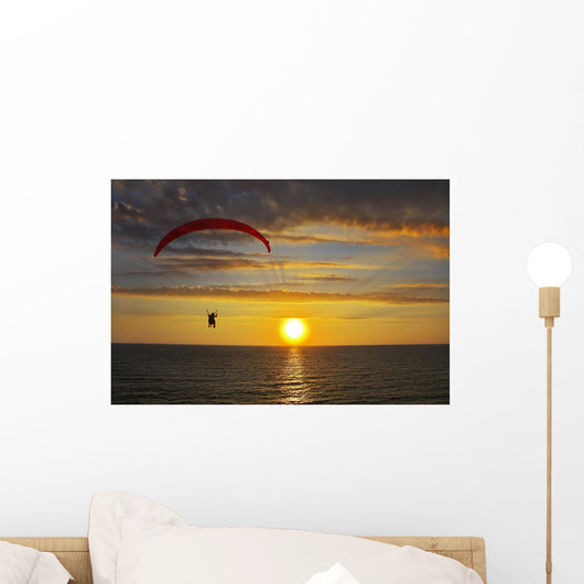 The parachute above the sea on a sunset Wall Mural