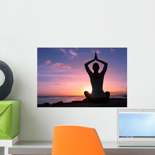 Young healthy woman practicing yoga on the beach at sunset
Wall Mural