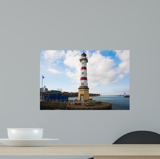 Old striped lighthouse in Oresund, Malmo city harbour Wall Mural