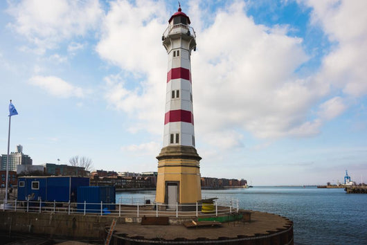 Old striped lighthouse in Oresund, Malmo city harbour Wall Mural