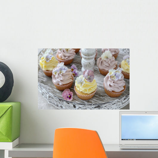 Purple and yellow cupcakes with sugared edible flowers on vintage cake stand Wall Mural