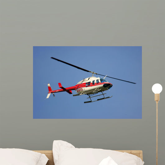 helicopter flying against a deep blue sky Wall Mural