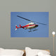 helicopter flying against a deep blue sky Wall Mural
