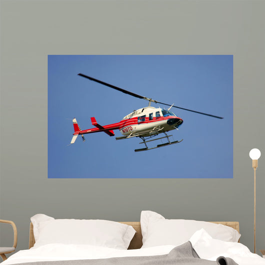 helicopter flying against a deep blue sky Wall Mural
