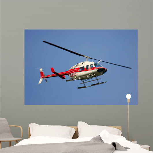 helicopter flying against a deep blue sky Wall Mural
