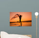 Silhouette of girl running on the beach Wall Mural