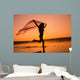 Silhouette of girl running on the beach Wall Mural