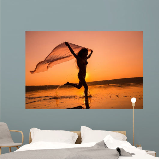 Silhouette of girl running on the beach Wall Mural