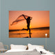 Silhouette of girl running on the beach Wall Mural