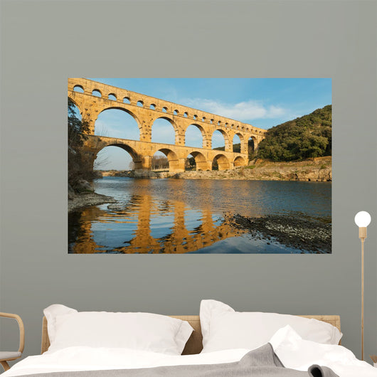 Famous Pont Du Gard reflecting in Gardon river in Southern France Wall Mural