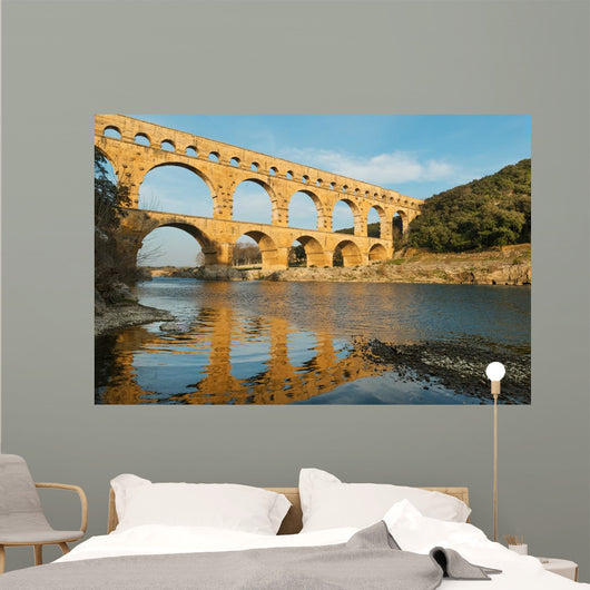 Famous Pont Du Gard reflecting in Gardon river in Southern France Wall Mural