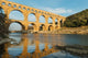 Famous Pont Du Gard reflecting in Gardon river in Southern France Wall Mural