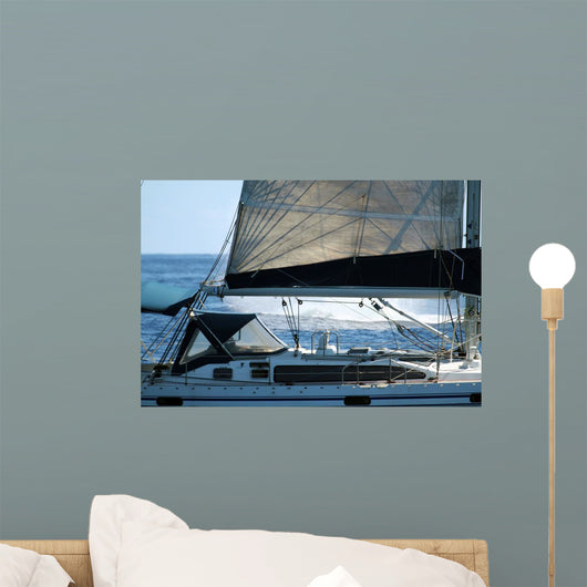 sailboat with a whale splash in background Wall Mural