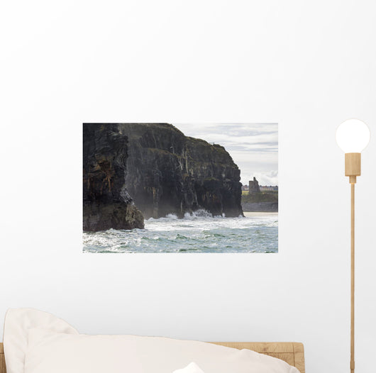 Dark straight cliffs with ruined castle turret Wall Mural
