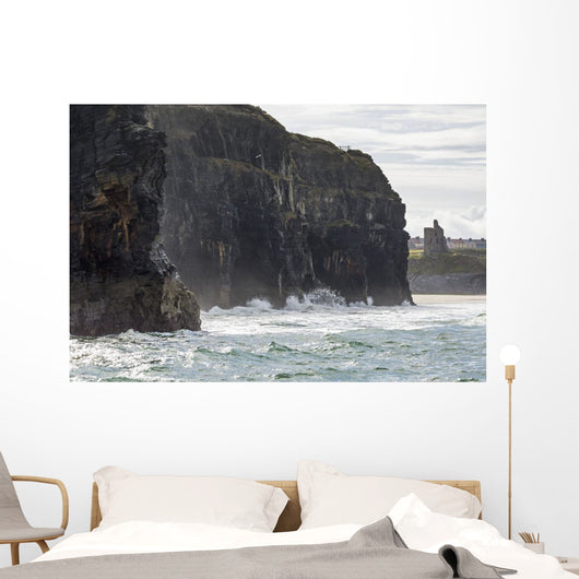 Dark straight cliffs with ruined castle turret Wall Mural