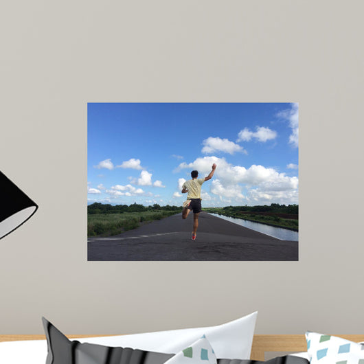 Man running away fast downhill Wall Mural