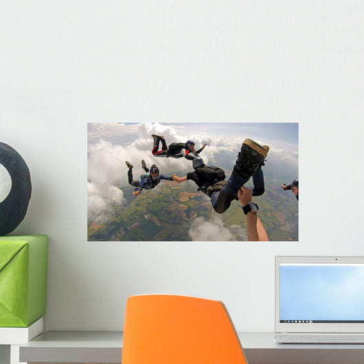 Skydiving point of view. Young and middle aged friends having fun Wall Mural
