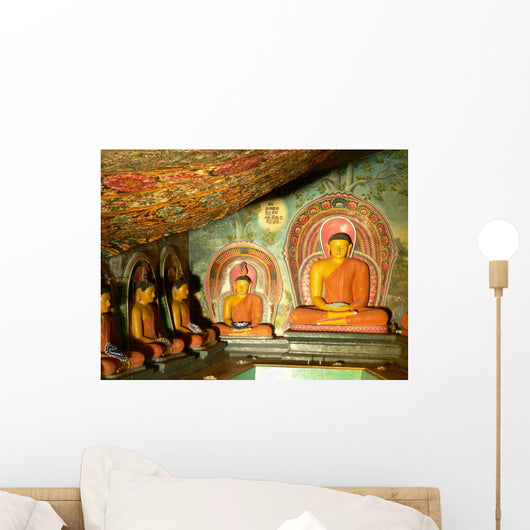 Statues of Lord Buddha Sorrounded by Paintings Wall Mural