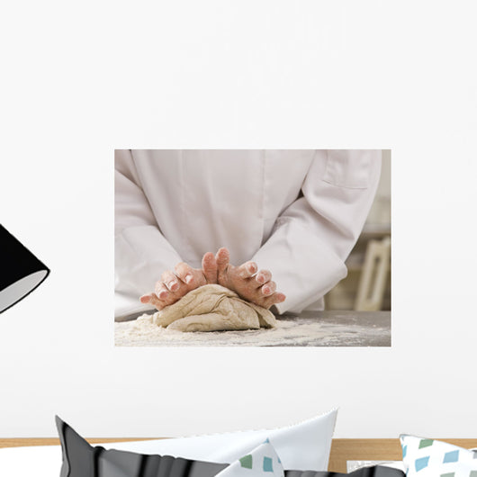 Chef kneading dough. Wall Mural