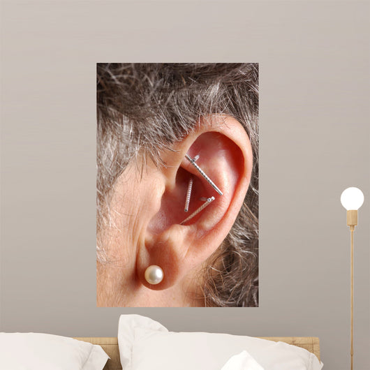 acupuncture needles in ear Wall Mural
