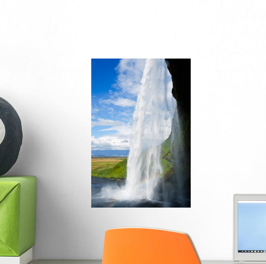 waterfall in a green landscape in Iceland Wall Mural
