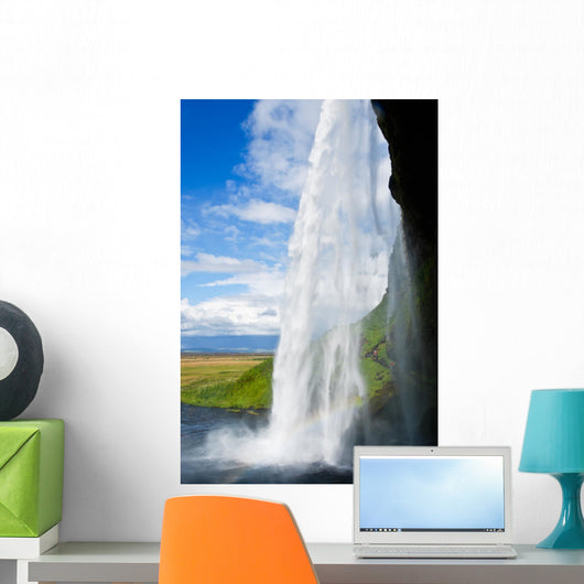waterfall in a green landscape in Iceland Wall Mural