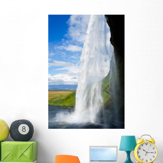 waterfall in a green landscape in Iceland Wall Mural