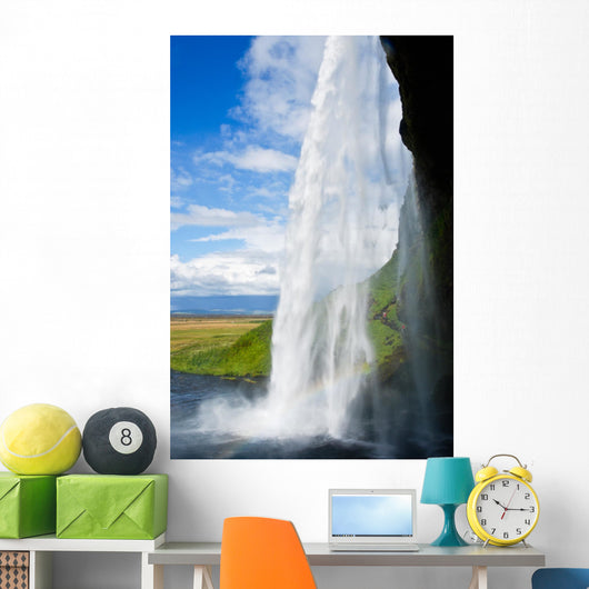waterfall in a green landscape in Iceland Wall Mural