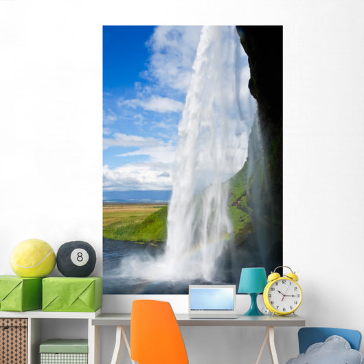 waterfall in a green landscape in Iceland Wall Mural