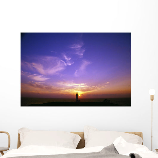 Luminous Sky Behind Distant Lighthouse Wall Mural