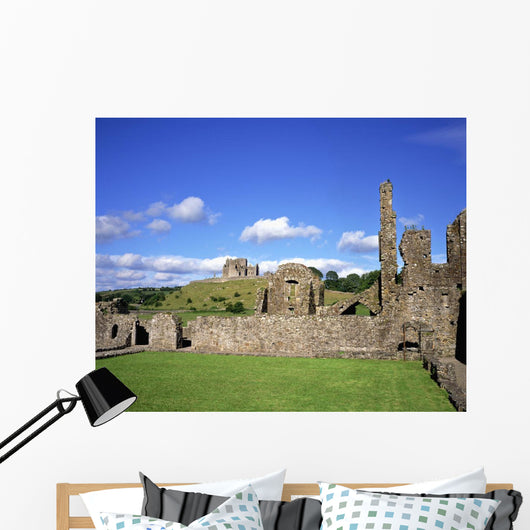 Old Ruins Of An Abbey With A Castle In The Background Wall Mural
