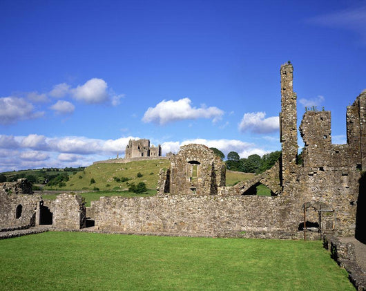 Old Ruins Of An Abbey With A Castle In The Background Wall Mural