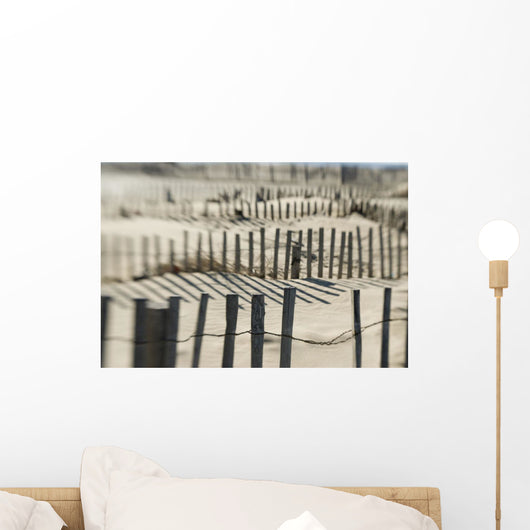 Slats Of Wooden Fence Throwing Shadows On Beach Wall Mural