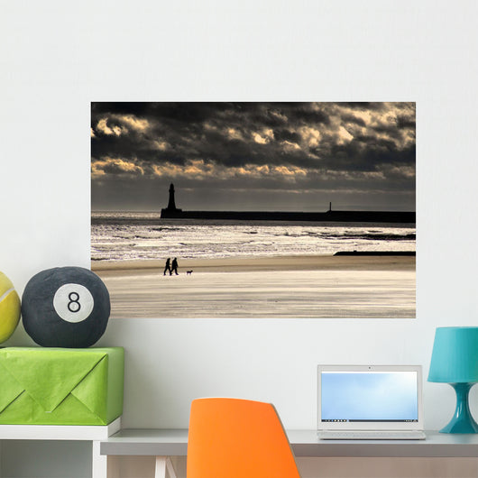 Scenic View Of Sandy Beach With Lighthouse And Groyne Wall Mural