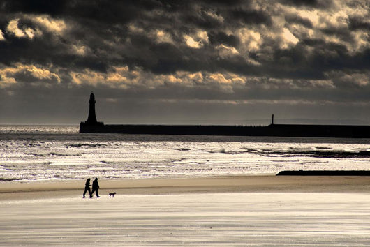 Scenic View Of Sandy Beach With Lighthouse And Groyne Wall Mural