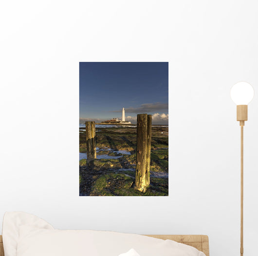 Wooden Posts And Lighthouse In Distance Wall Mural