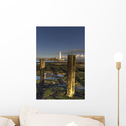Wooden Posts And Lighthouse In Distance Wall Mural
