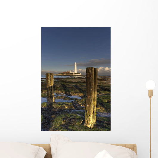 Wooden Posts And Lighthouse In Distance Wall Mural